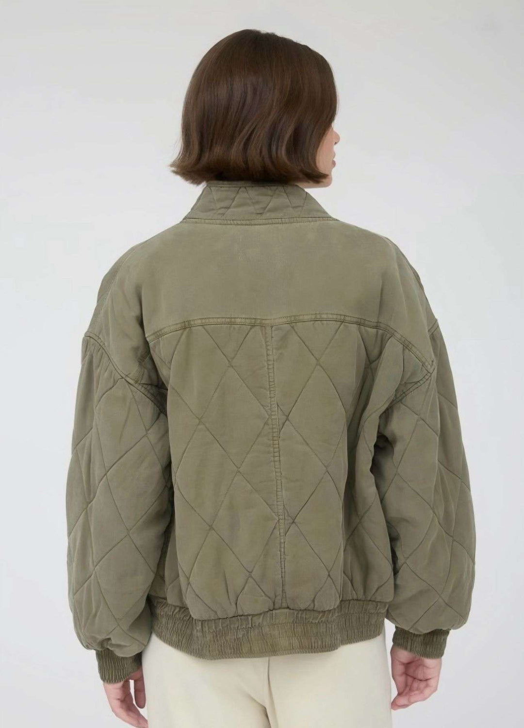 Olive quilted button-down jacket with front pockets and classic collar, lightweight fall outerwear for men and women.