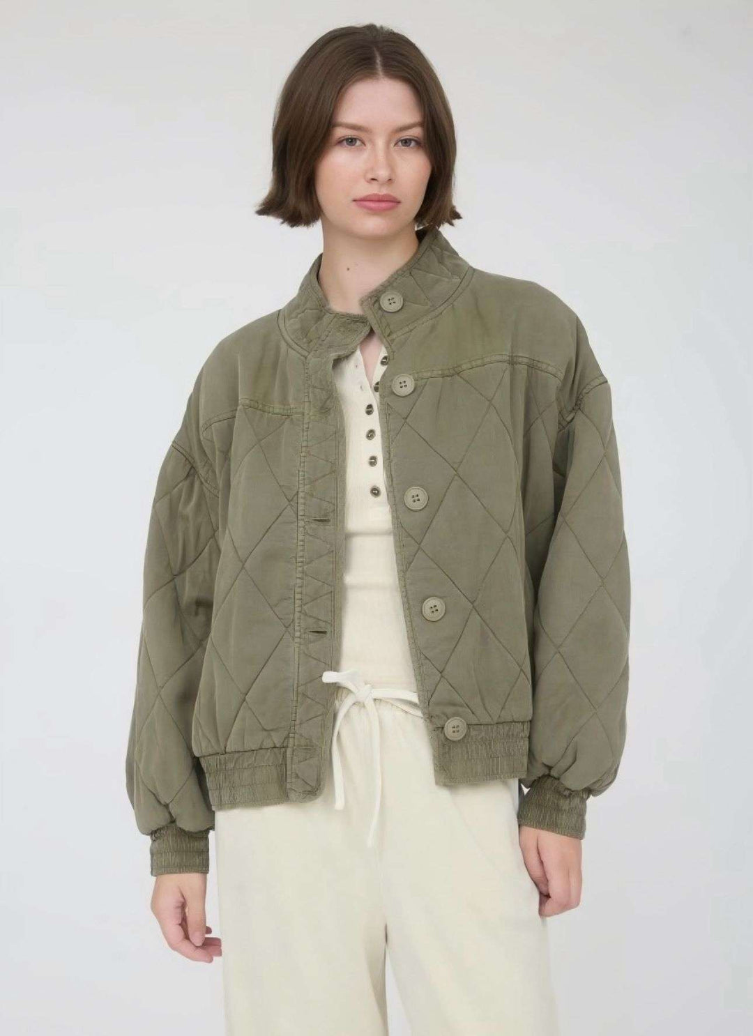 Olive quilted button-down jacket with front pockets and classic collar, lightweight fall outerwear for men and women.