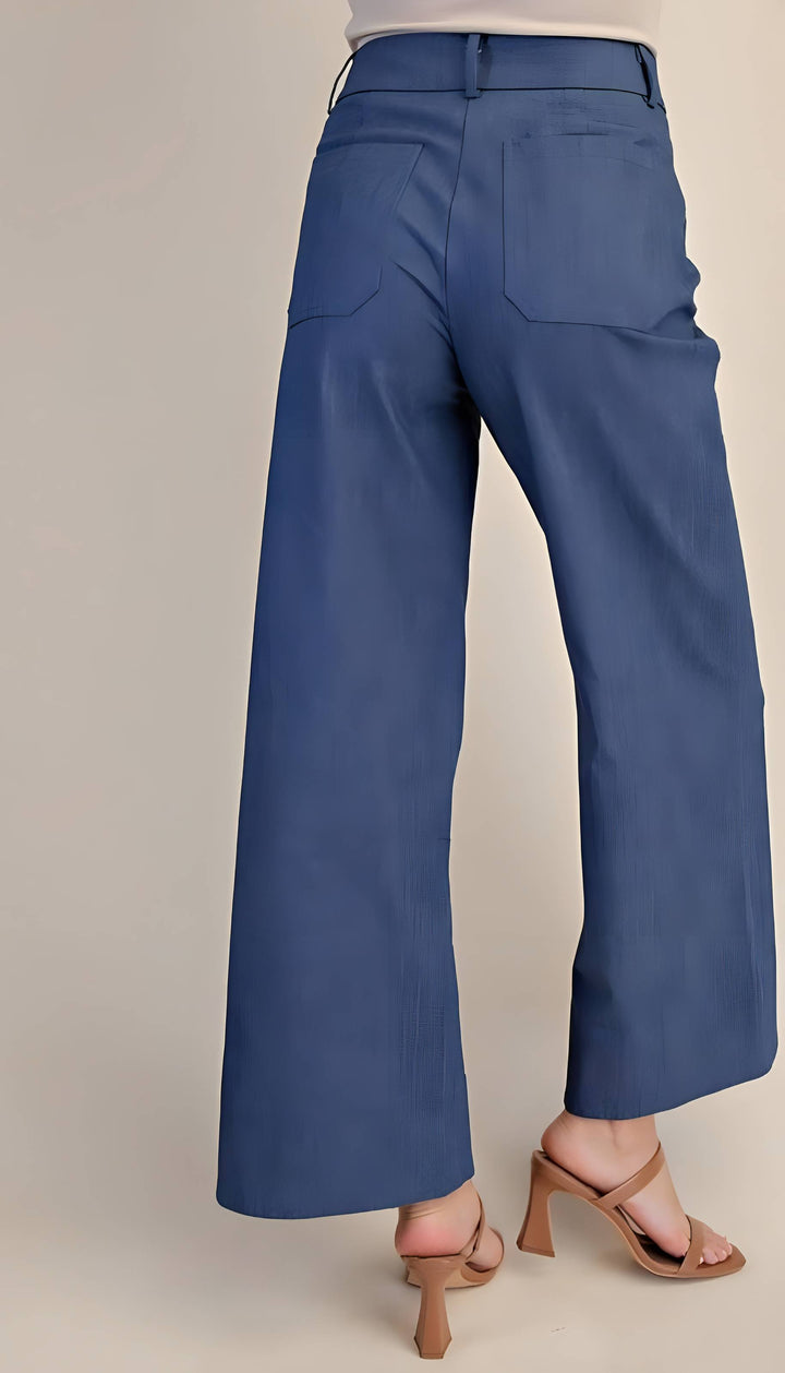 Blue pants worn by a person on a beige background