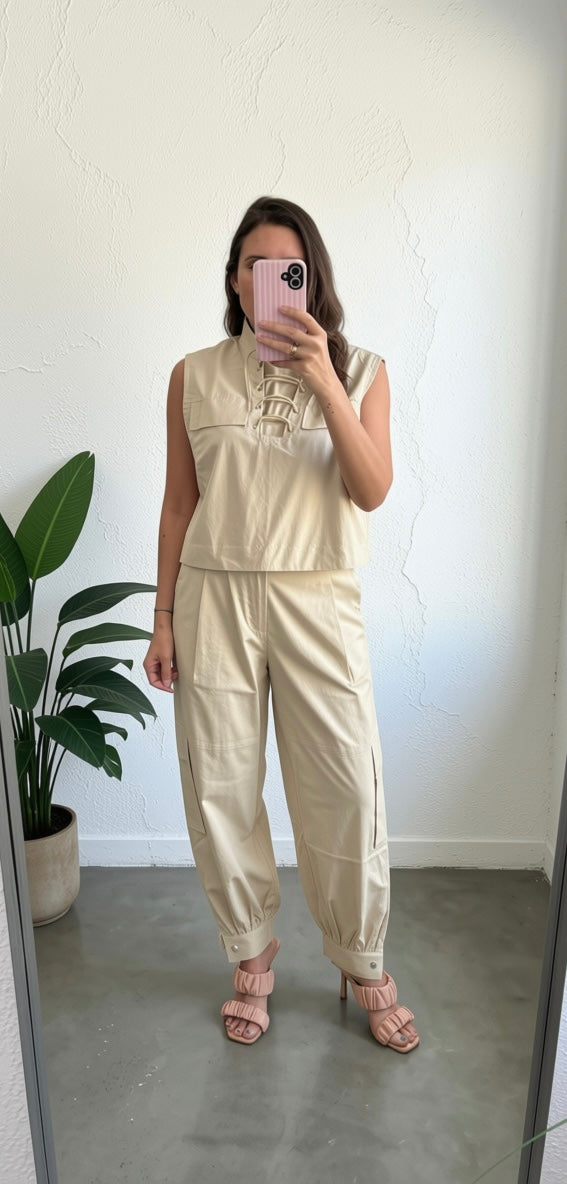 Woman wearing a lace up top wih slouchy pants