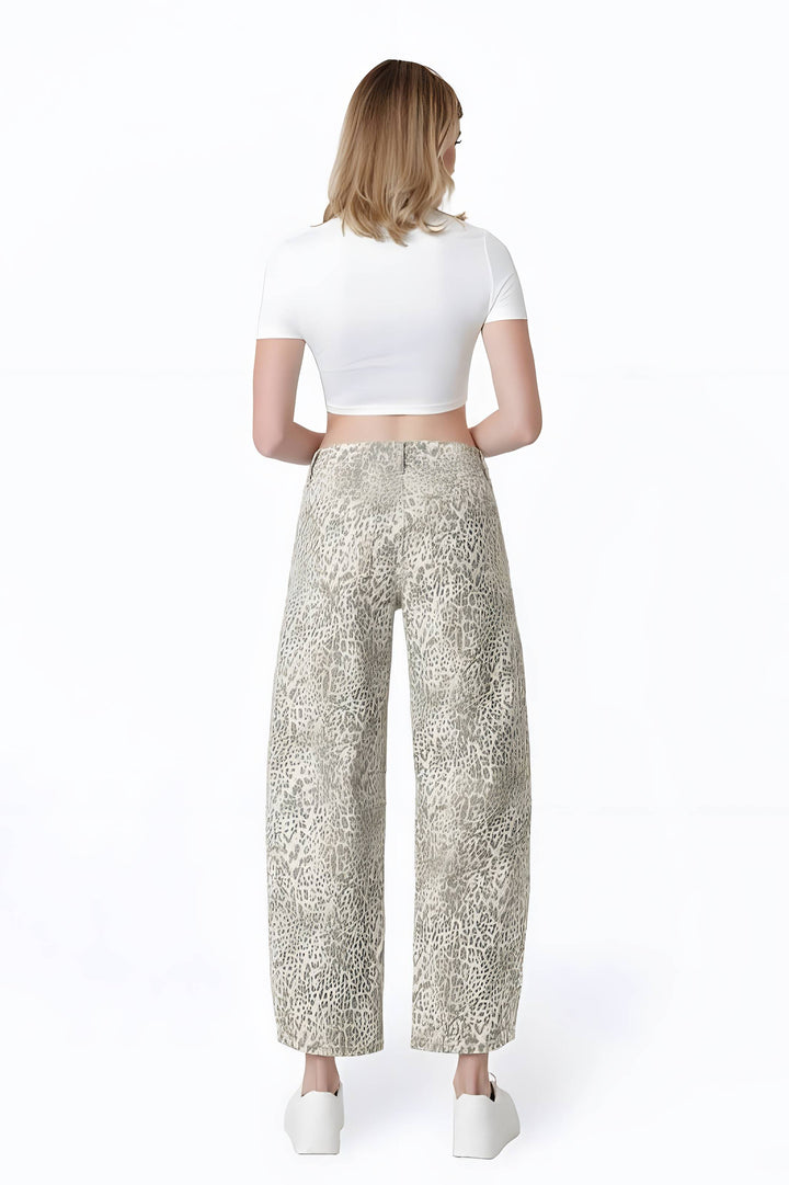 A woman shown from the back wearing wide-leg cropped pants with a beige and gray animal print, a white short-sleeve crop top, and white platform shoes against a plain white background.