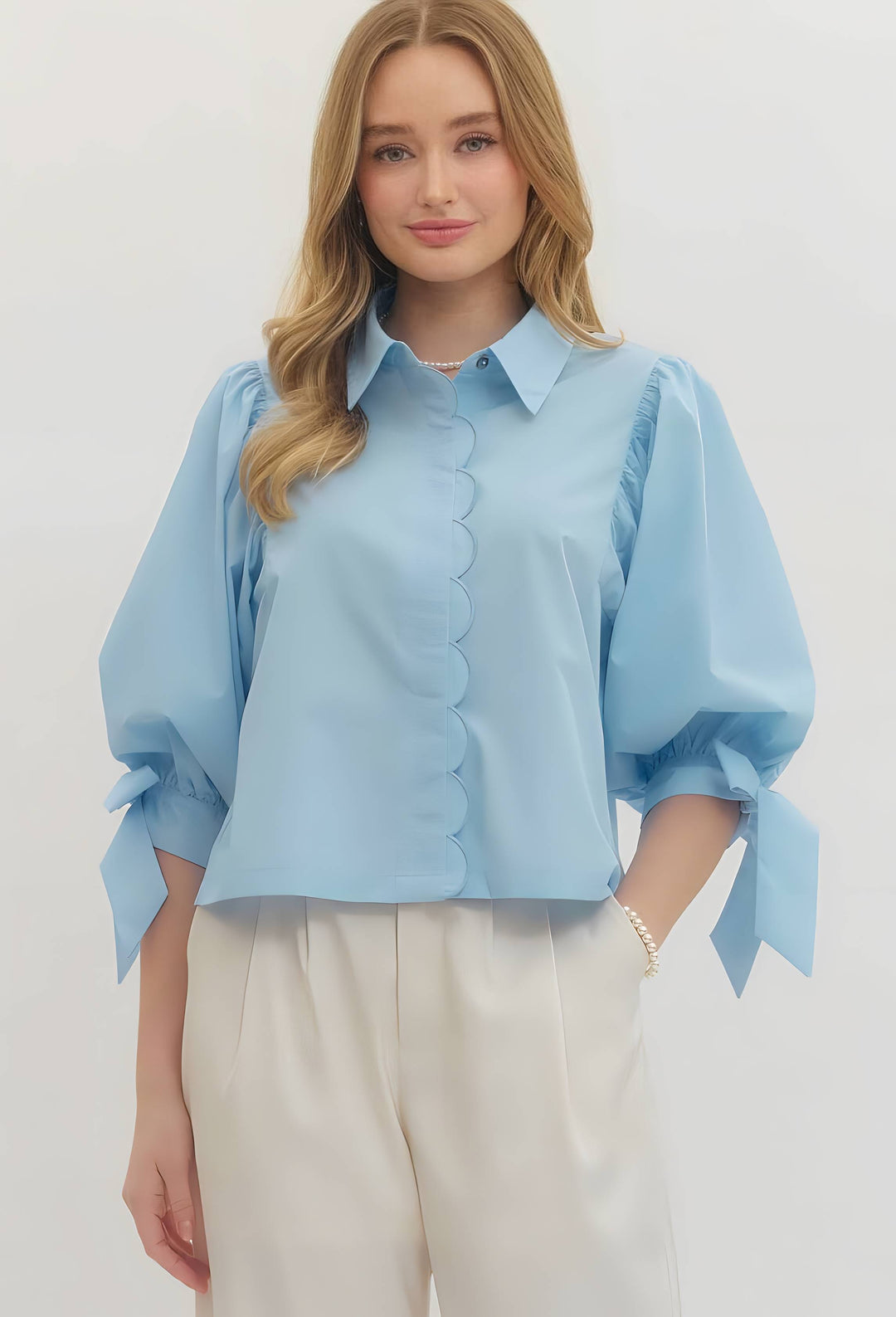 Light blue scallop top for women featuring delicate scalloped edges, lightweight fabric, and a flattering feminine fit for chic everyday boutique style.