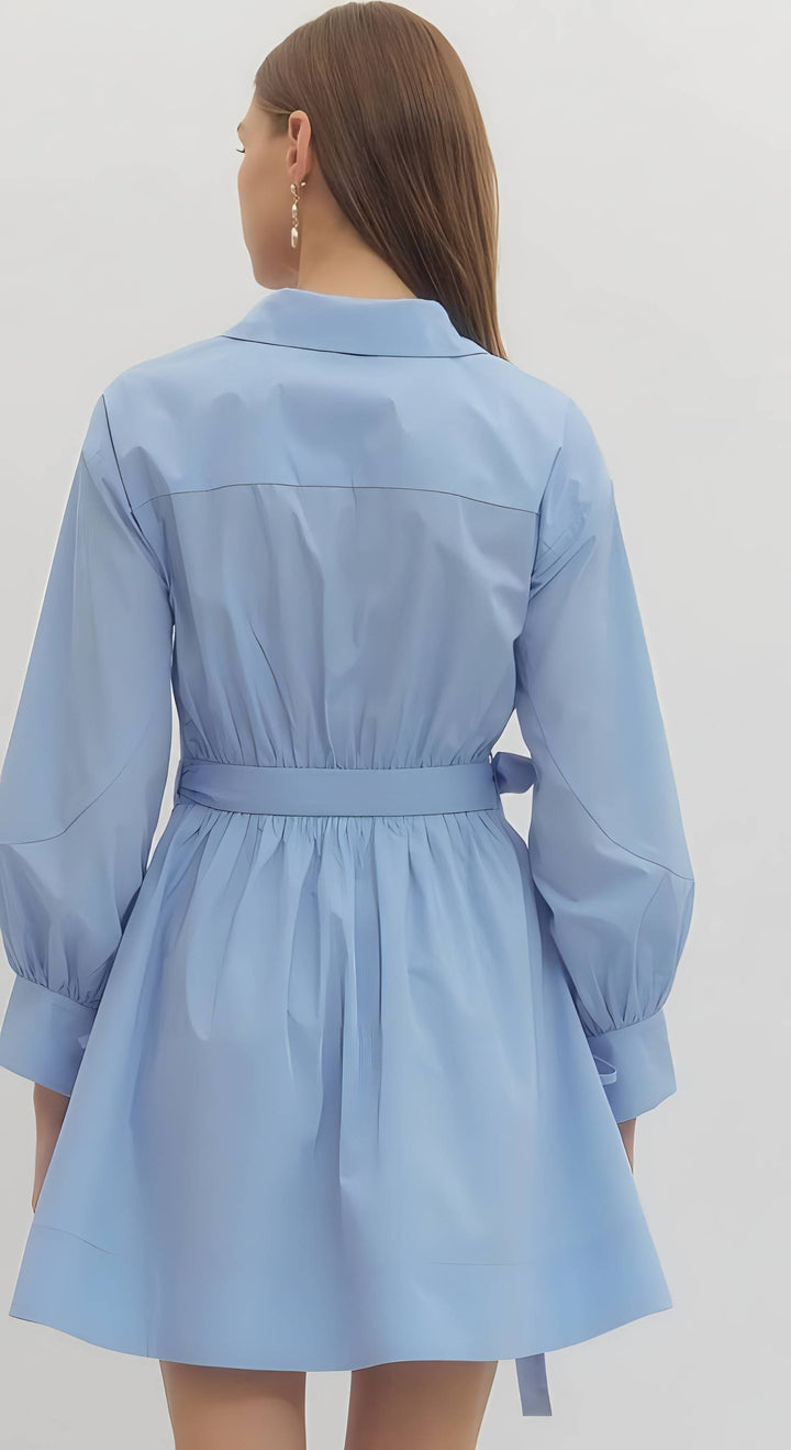 Light blue dress worn by a person on a plain background