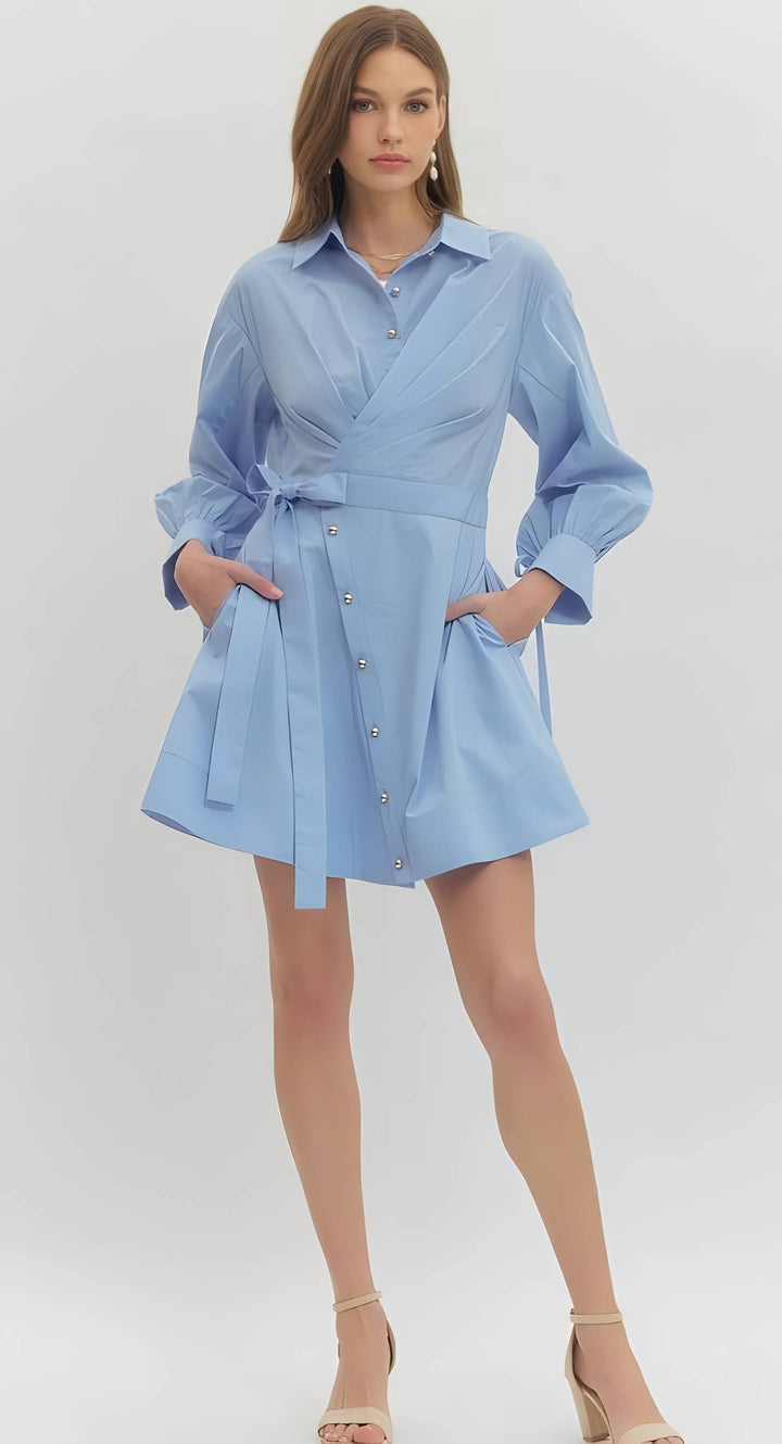 Woman wearing a light blue dress with a white background
