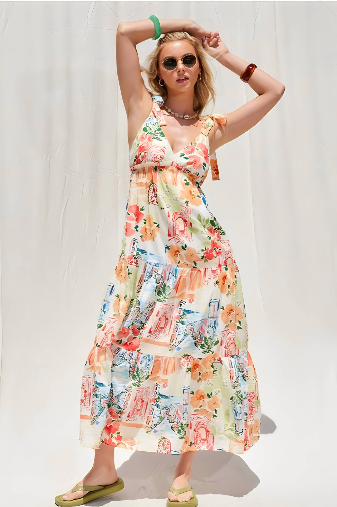 Woman wearing a colorful floral dress against a white background