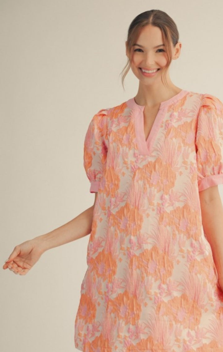 Woman wearing a floral dress with a neutral background