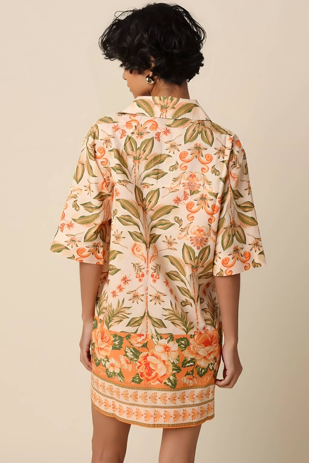 Woman wearing a floral dress with a beige background