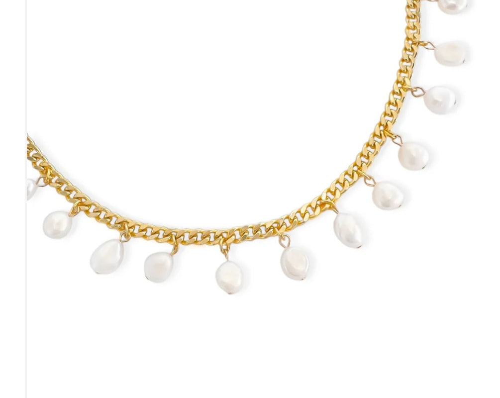 Gold chain necklace with white pearls on a white background