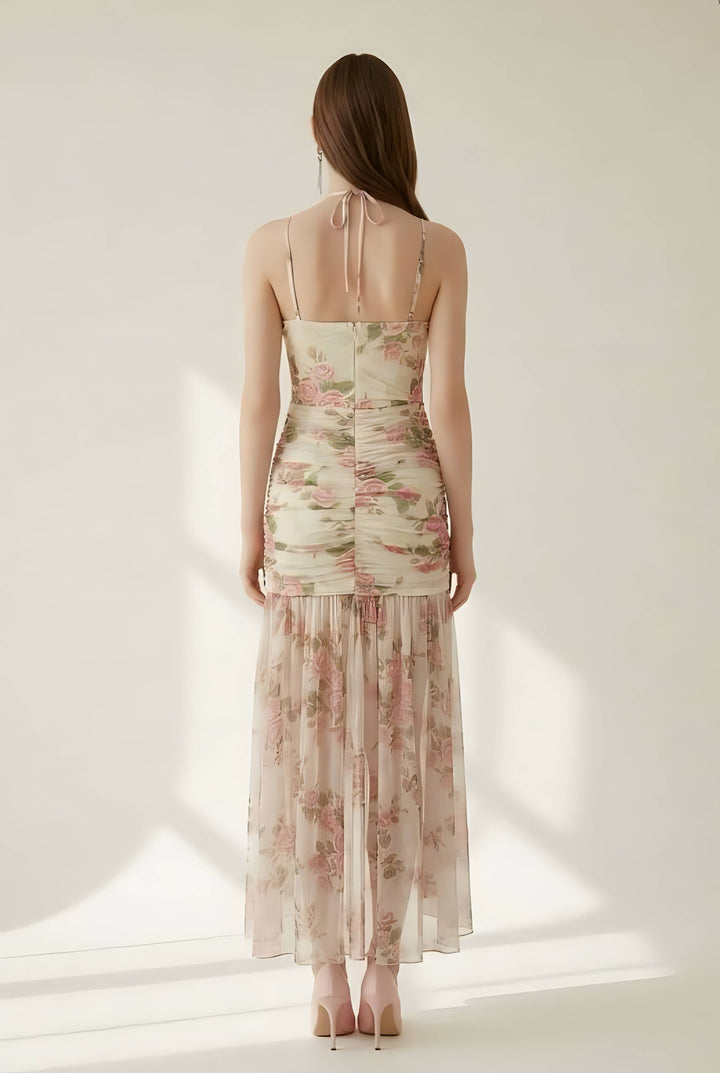 Woman wearing a floral dress with thin straps on a white background
