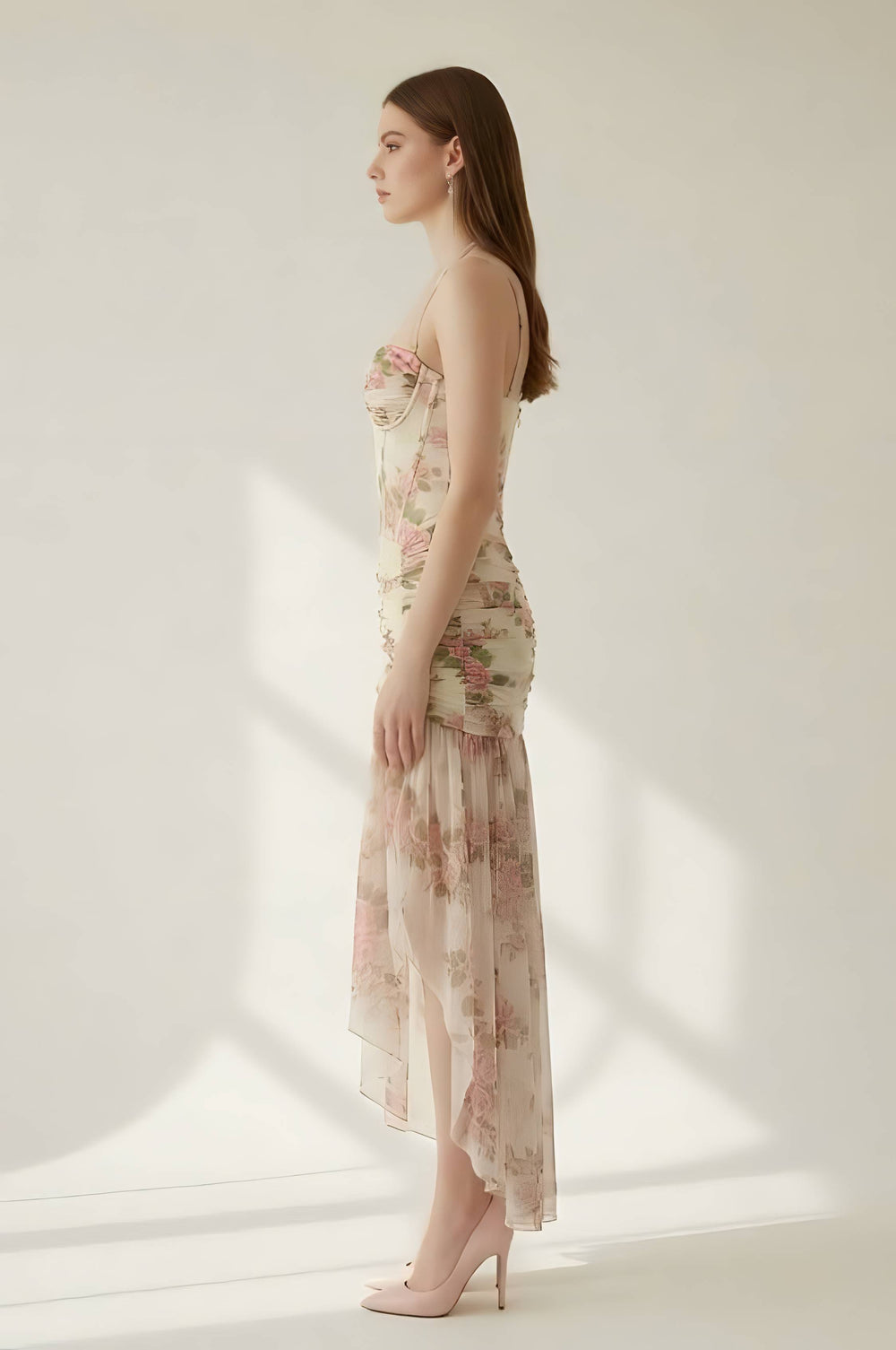 Woman wearing a floral dress against a white background