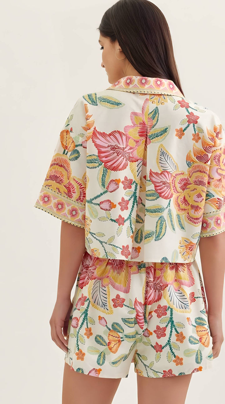 Woman wearing a floral two-piece set on a white background