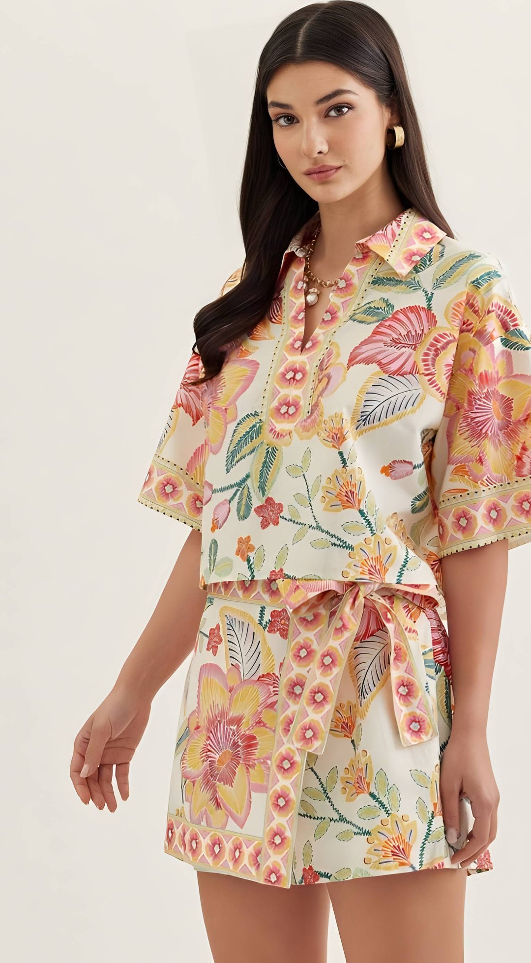 Woman wearing a floral outfit on a white background