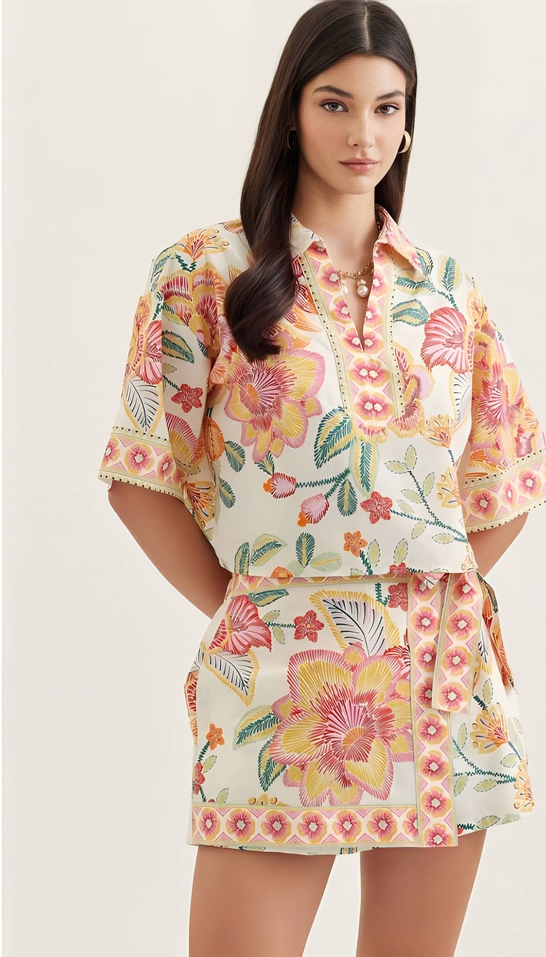 Woman wearing a floral dress with a plain background