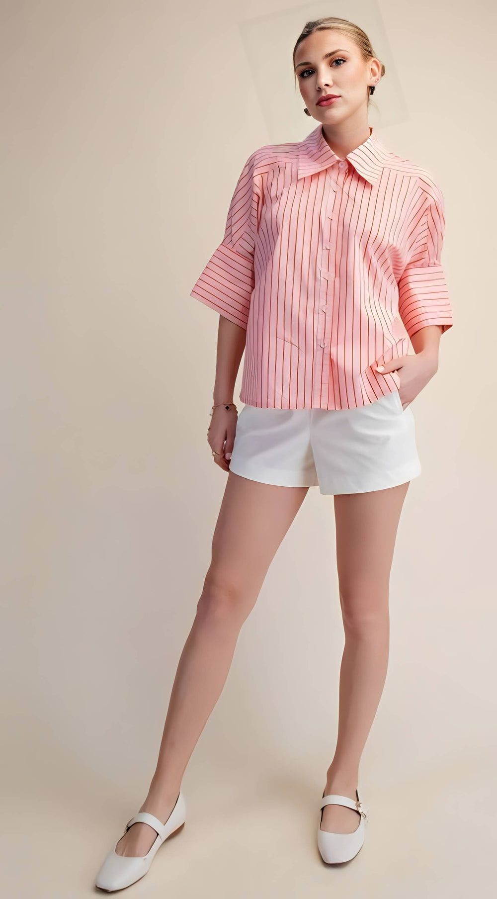 Woman wearing a pink striped shirt and white shorts on a beige background