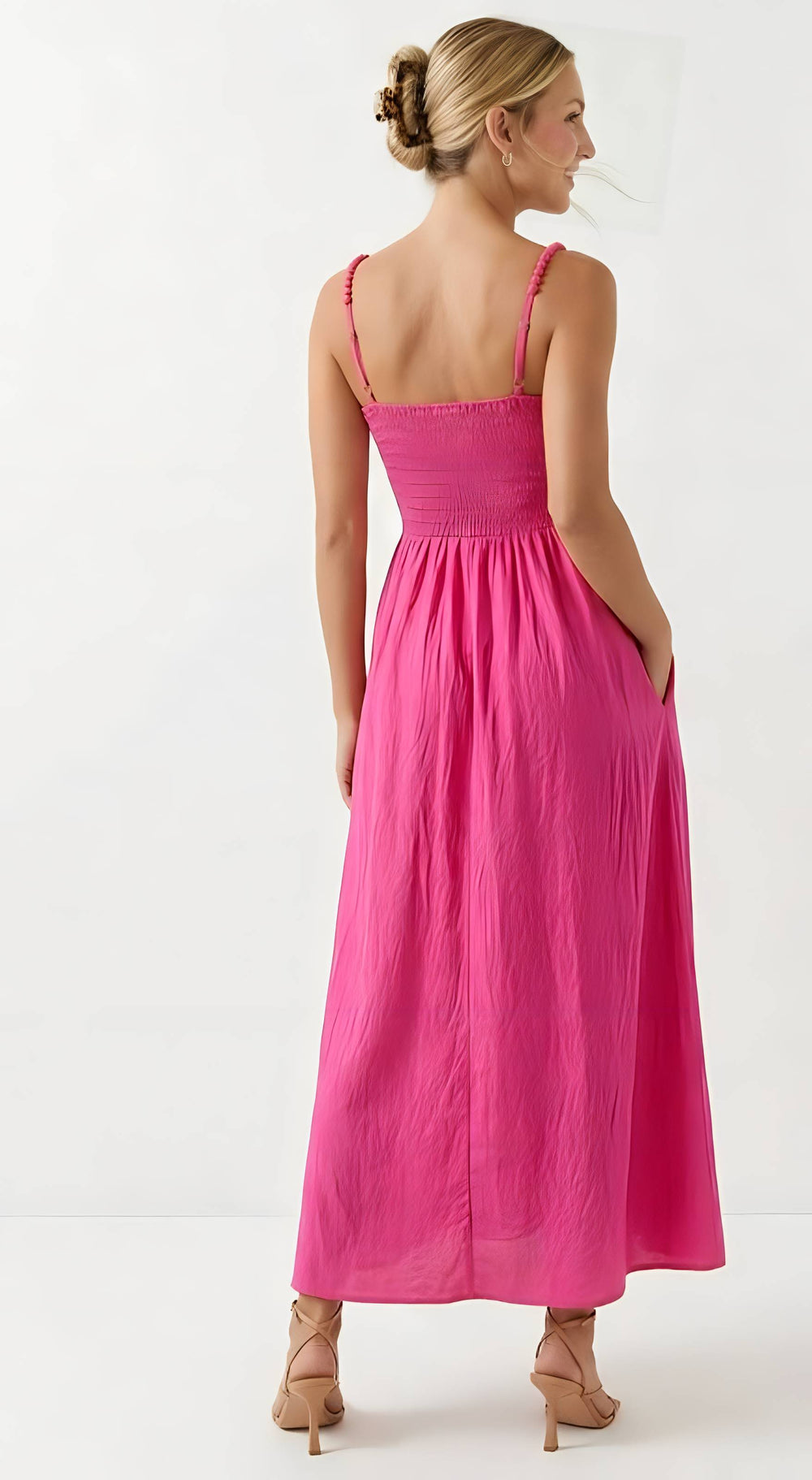 Woman wearing a pink dress on a white background