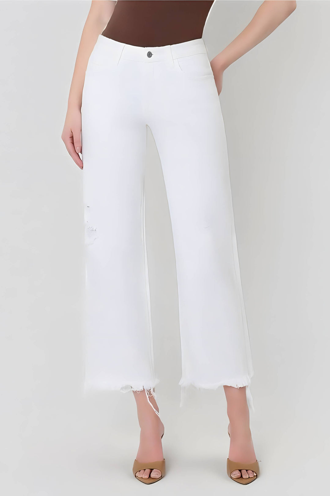 White pants worn by a person on a white background