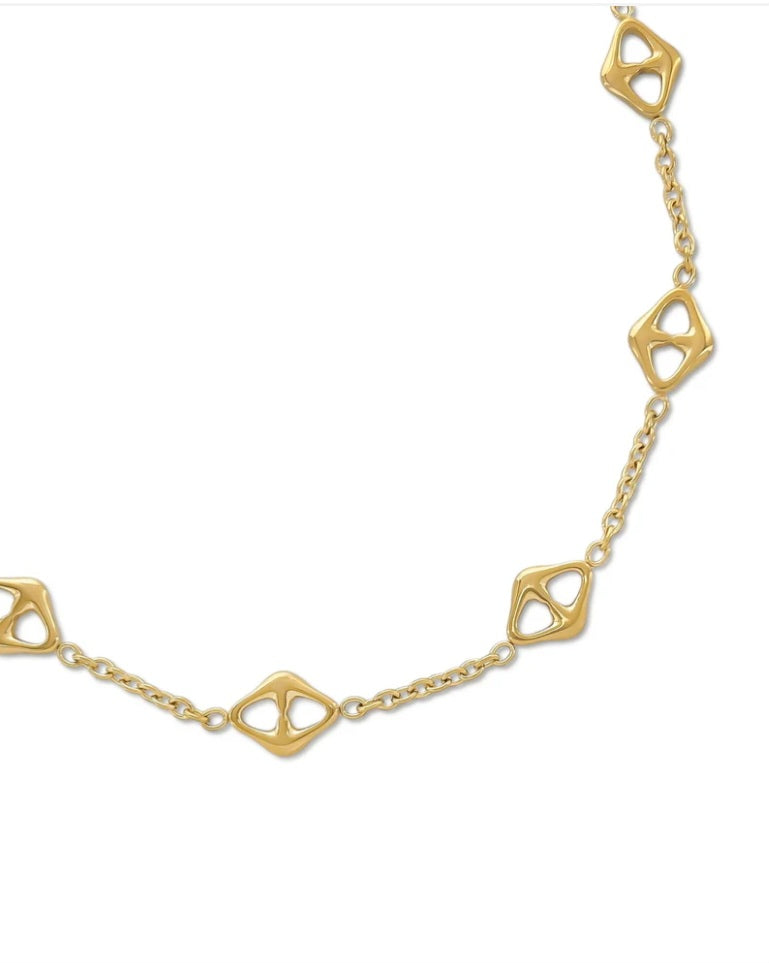 Gold chain with geometric links on a white background