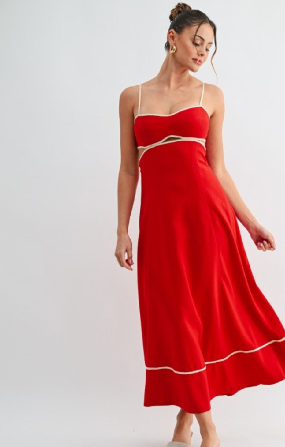 Woman wearing a red dress with a white trim on a light gray background