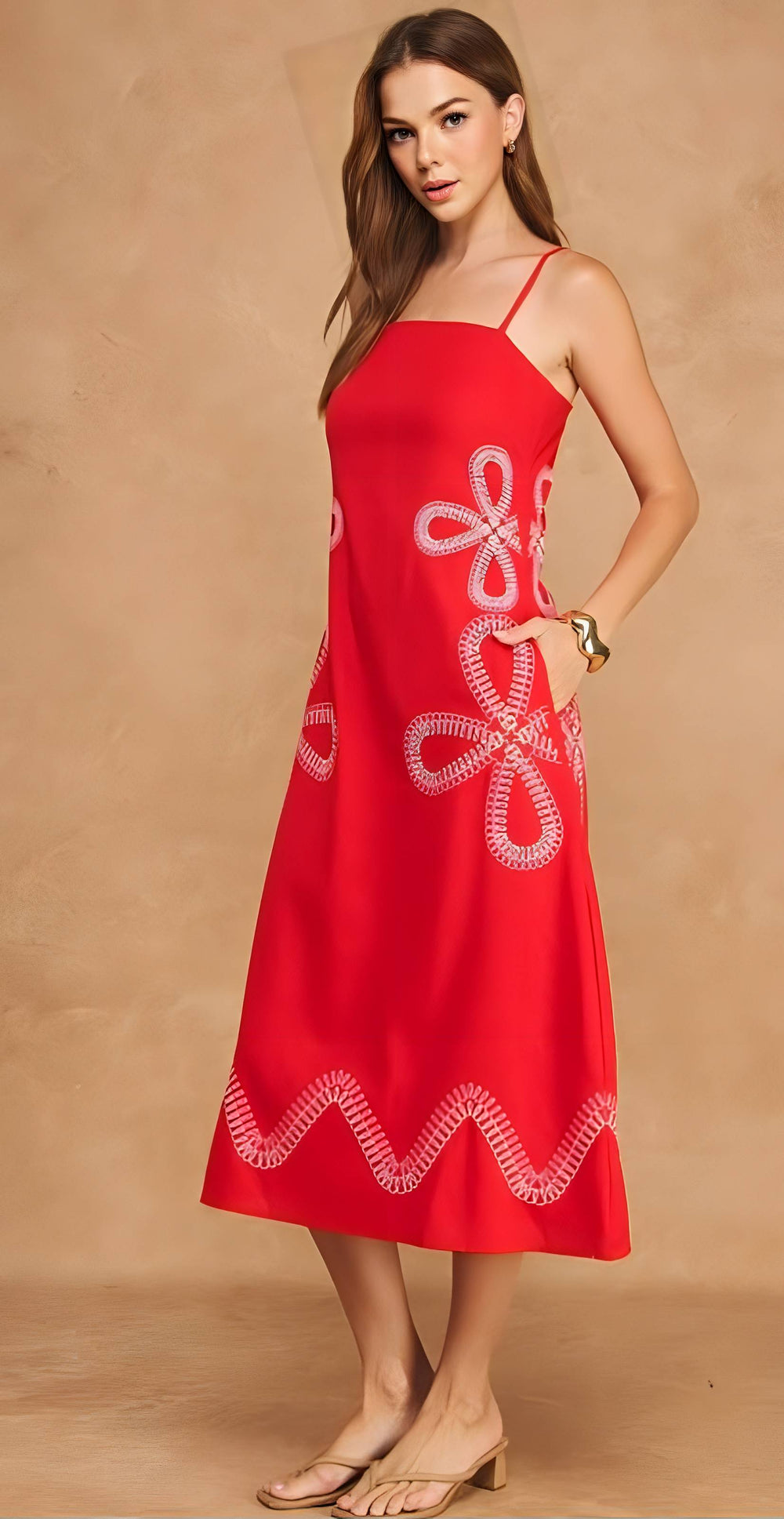 Woman wearing a red dress with white embroidery on a beige background
