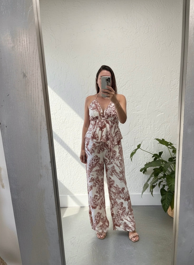Person wearing a floral pant set standing in front of a mirror.