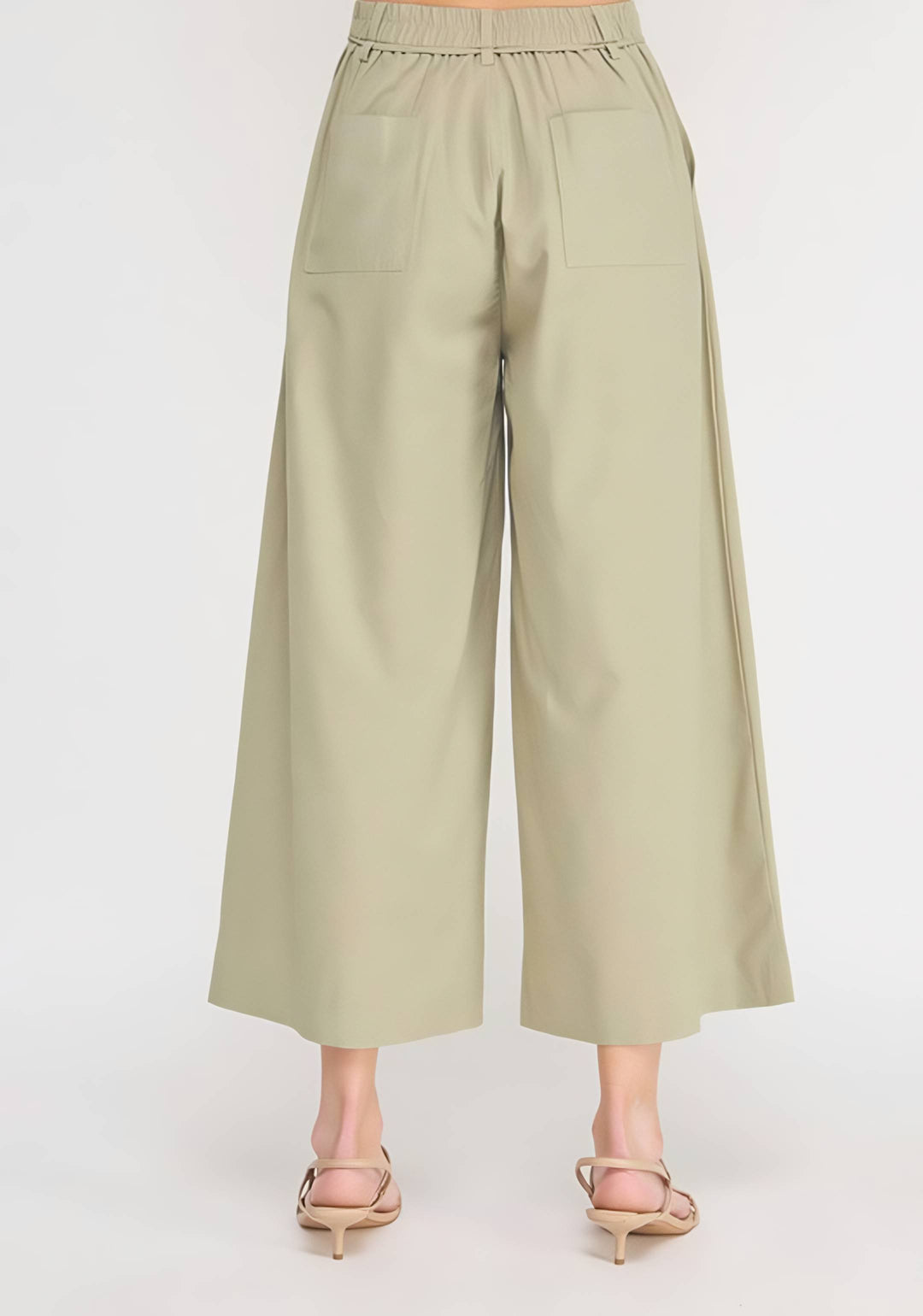 Light green wide-leg pants worn by a person on a white background