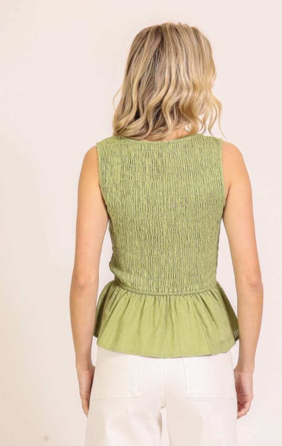 Olive green smocked tie front peplum top with flattering fit and feminine details, perfect for casual or dressy outfits.