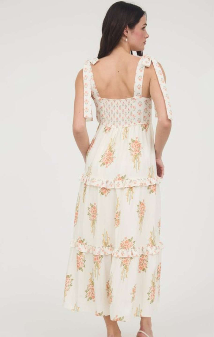 Soft peach dress with vibrant floral bouquet print, feminine sleeveless design for spring and summer wear