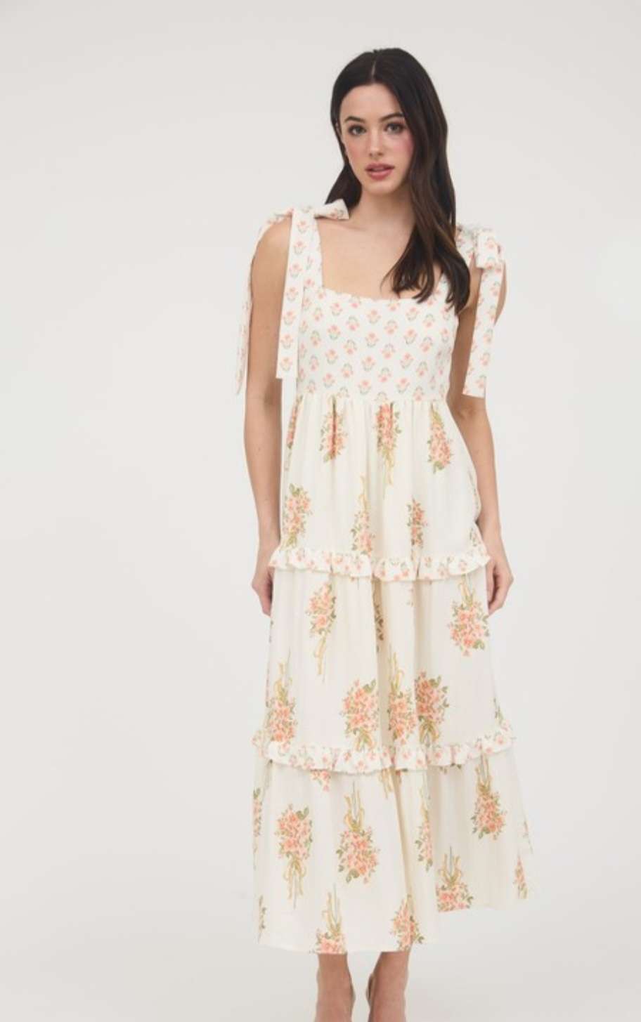 Soft peach dress with vibrant floral bouquet print, feminine sleeveless design for spring and summer wear