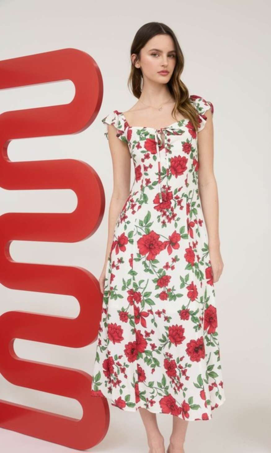 Women's white floral midi dress with soft flowy fabric, sleeveless design, and elegant summer garden party style