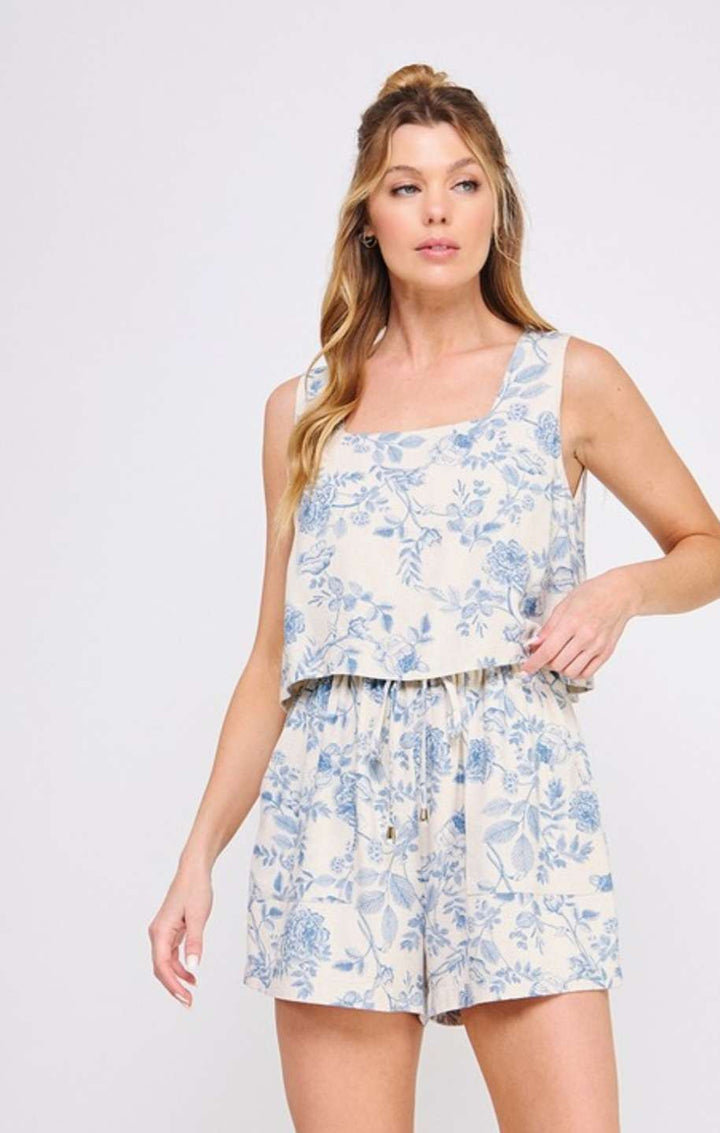 Women's light blue floral romper with square neckline and overlap top design – chic and lightweight summer outfit