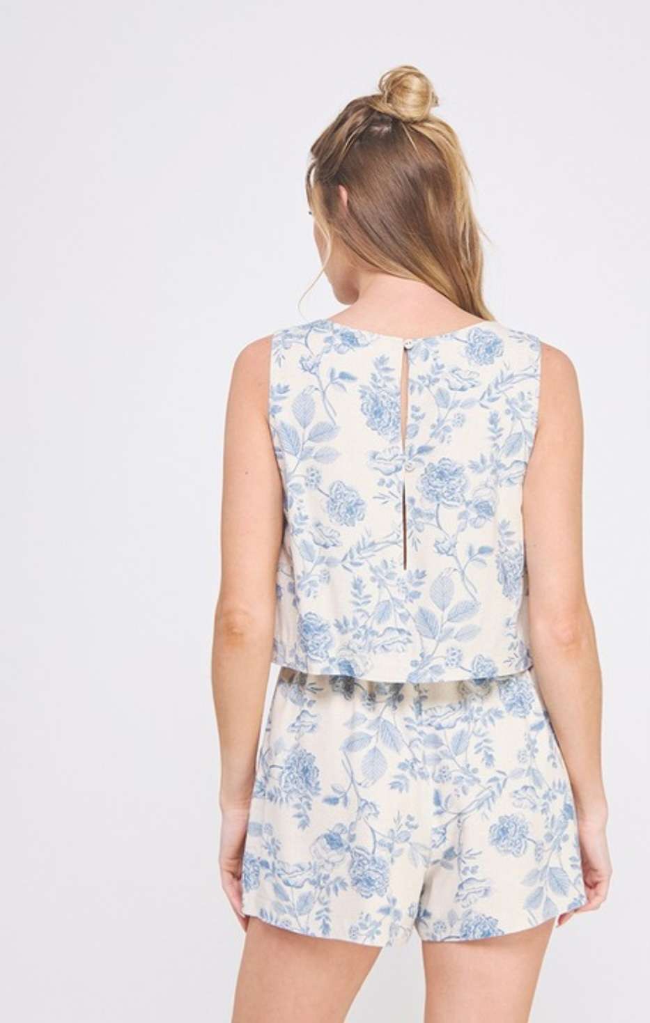 Women's light blue floral romper with square neckline and overlap top design – chic and lightweight summer outfit