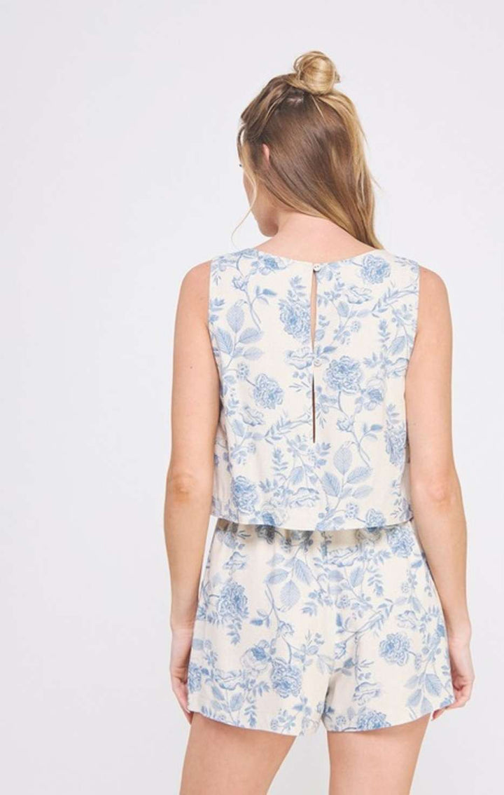 Women's light blue floral romper with square neckline and overlap top design – chic and lightweight summer outfit