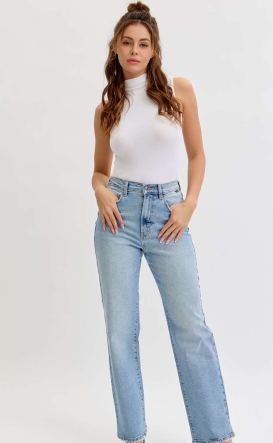 Women's light denim high rise jeans with a slim fit and classic five-pocket design, perfect for casual everyday wear.