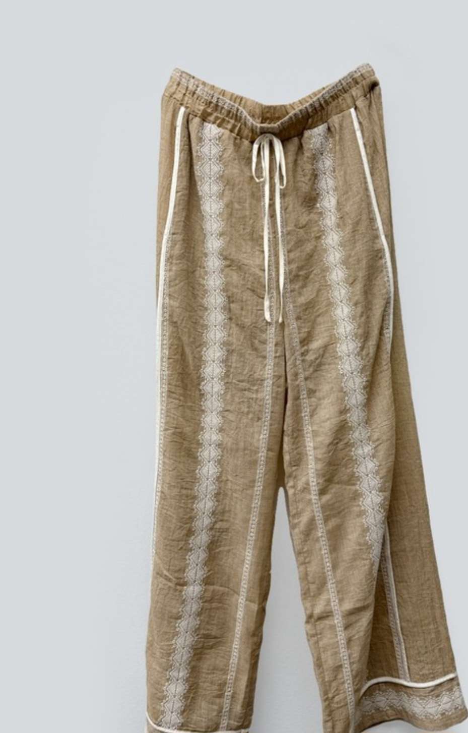 Boho-inspired taupe pants with elastic waistband and decorative embroidery
