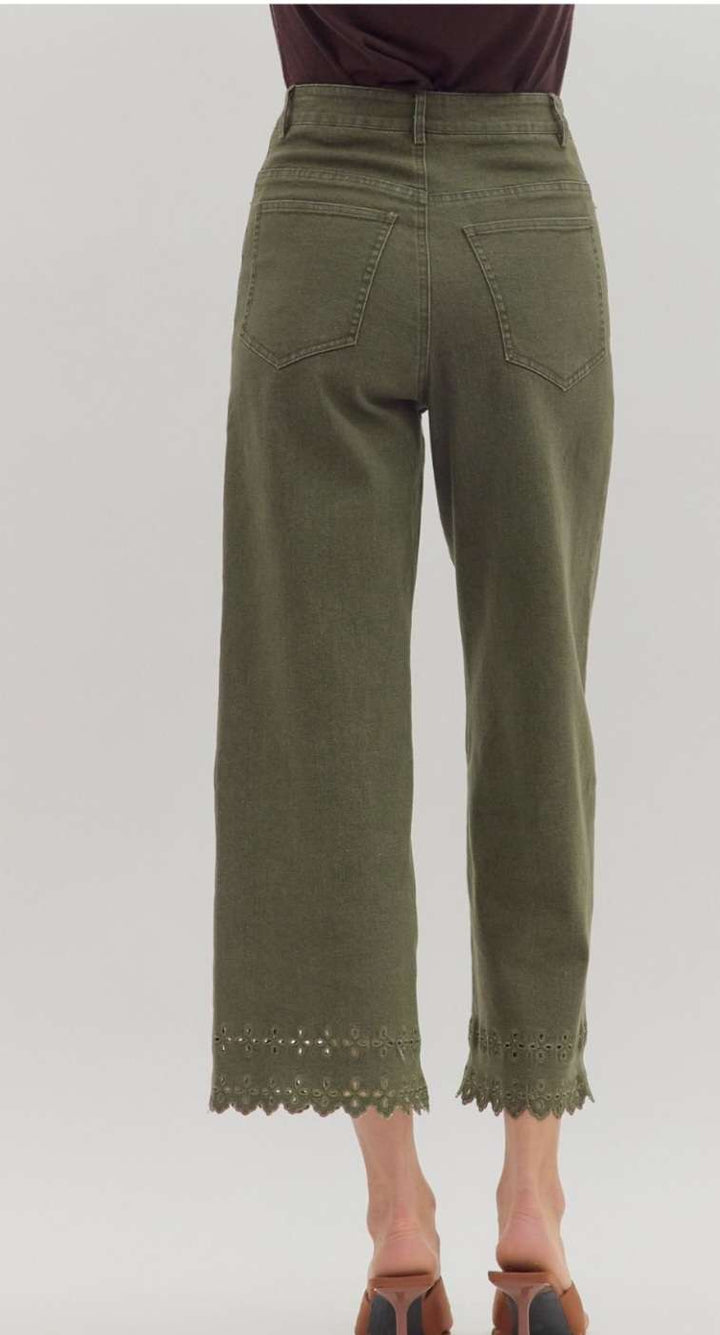 Women's olive green denim pants with eyelet hem detail, stylish high-waisted fit, and ankle-length cut for casual or dressy outfits.
