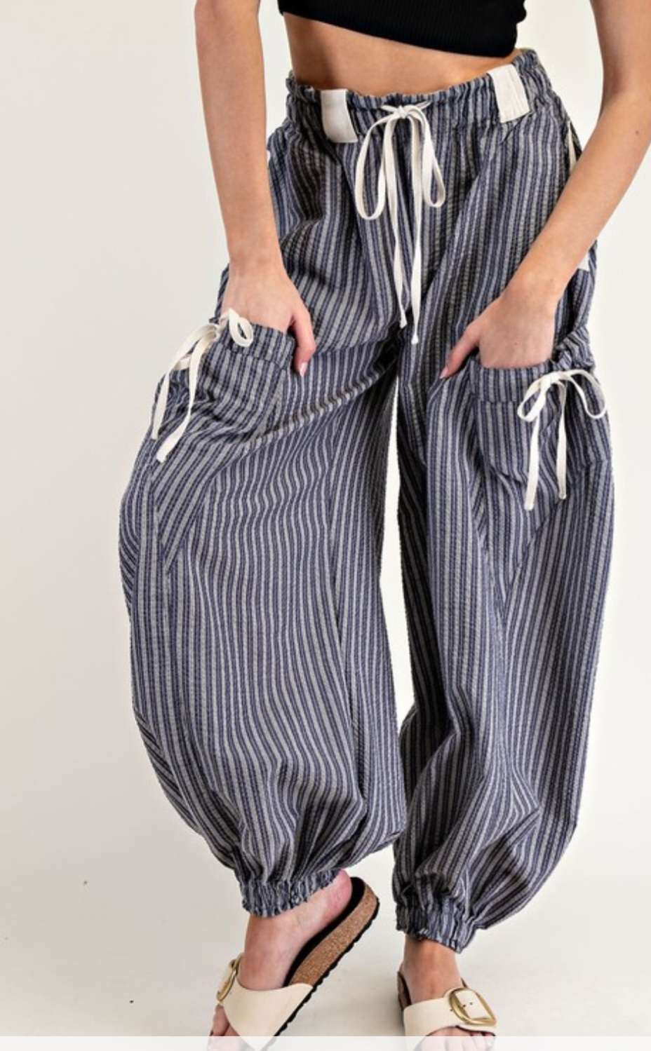 Women's navy stripe joggers with elastic waistband and side pockets – casual, comfortable athleisure pants for everyday wear.