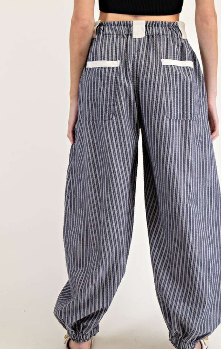 Women's navy stripe joggers with elastic waistband and side pockets – casual, comfortable athleisure pants for everyday wear.