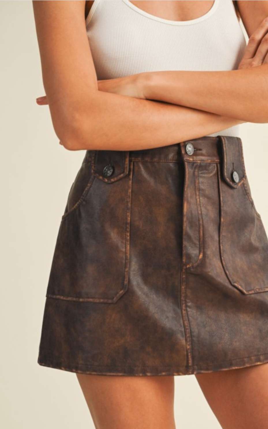 Trendy brown pleather mini skirt for women – faux leather design, perfect for night outs, fall fashion, and edgy street style looks.