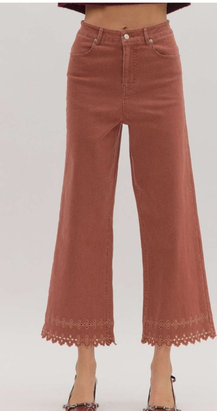 High-waisted brick denim pants featuring decorative eyelet hem