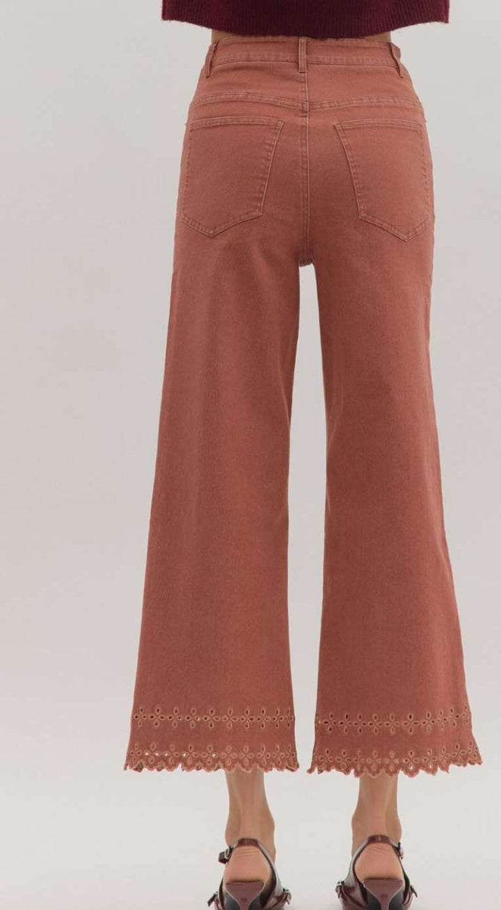 High-waisted brick denim pants featuring decorative eyelet hem