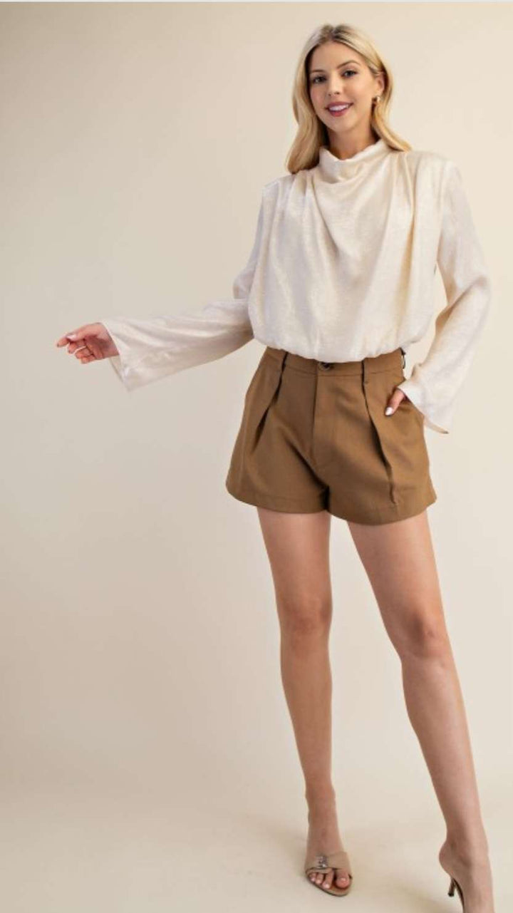 Chic cream high neck blouse featuring long sleeves and a minimalist design