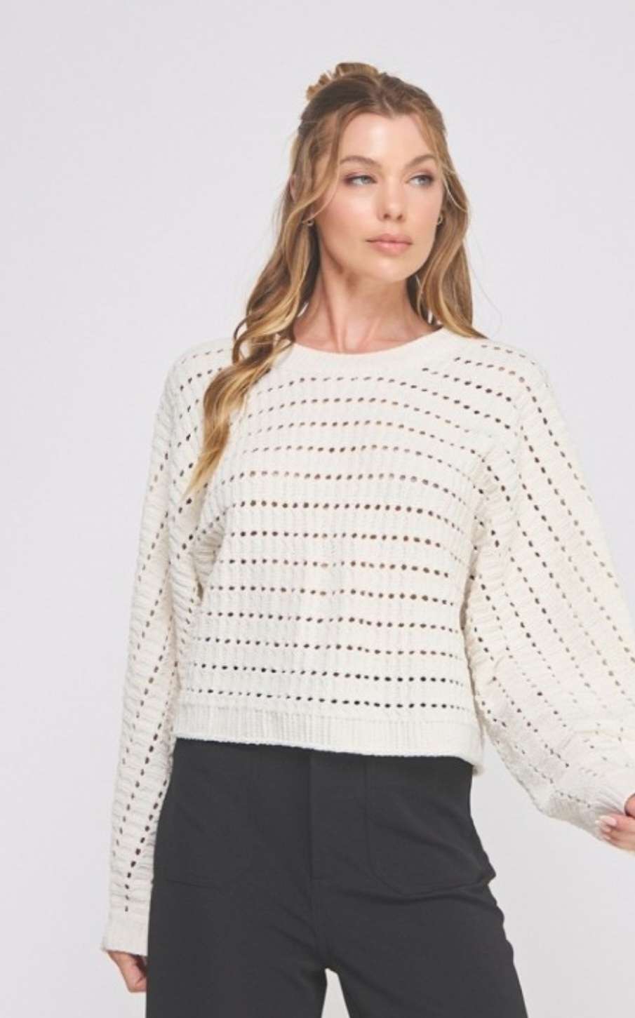 Soft cream cropped sweater featuring delicate pointelle knit pattern and long sleeves