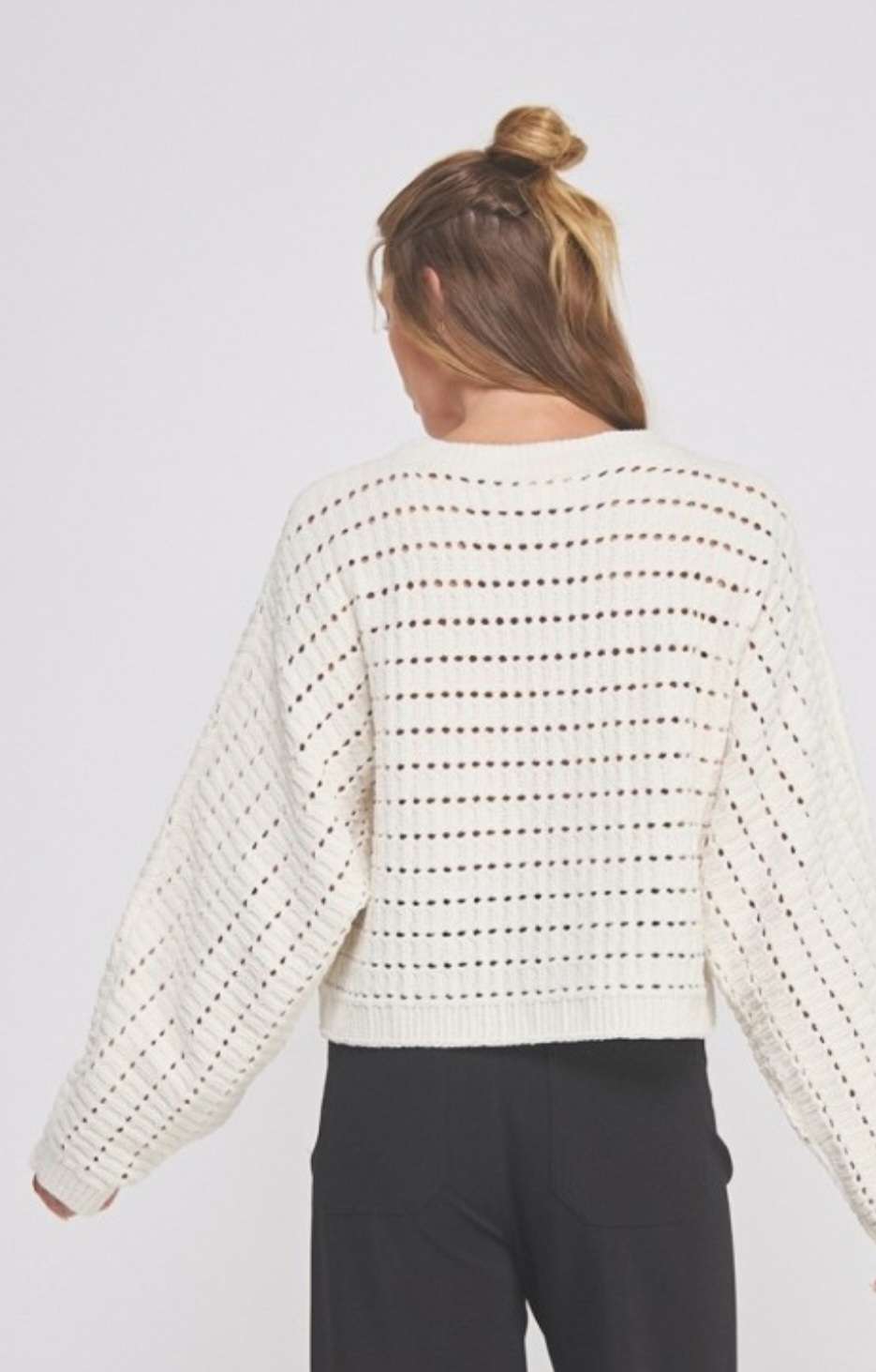 Soft cream cropped sweater featuring delicate pointelle knit pattern and long sleeves