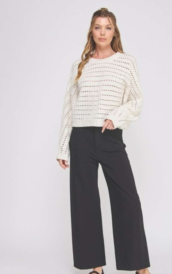Soft cream cropped sweater featuring delicate pointelle knit pattern and long sleeves