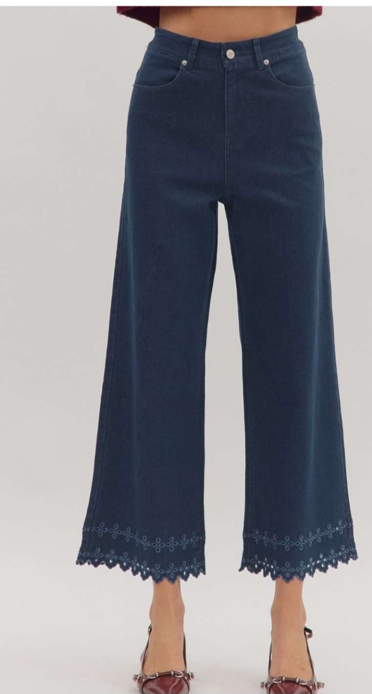 High-waisted brown denim pants featuring decorative eyelet hem