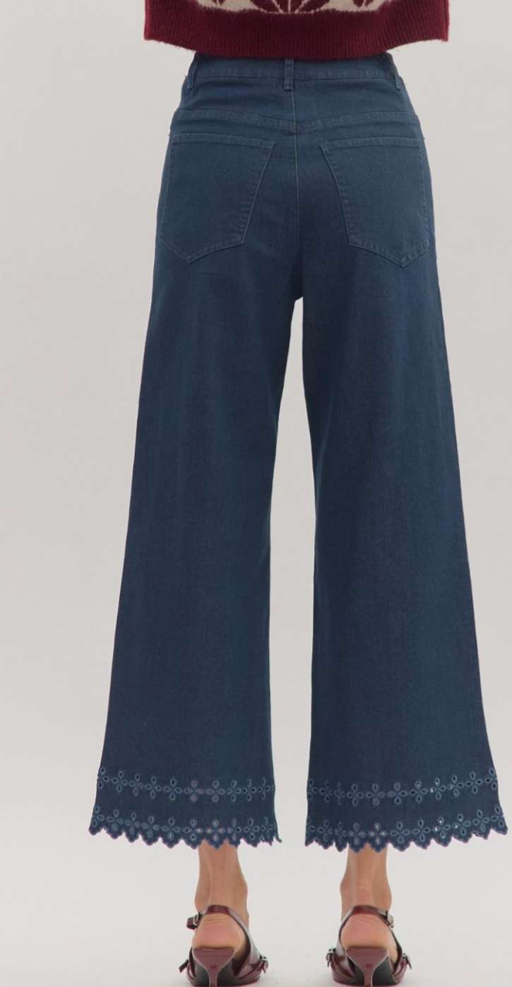 High-waisted brown denim pants featuring decorative eyelet hem