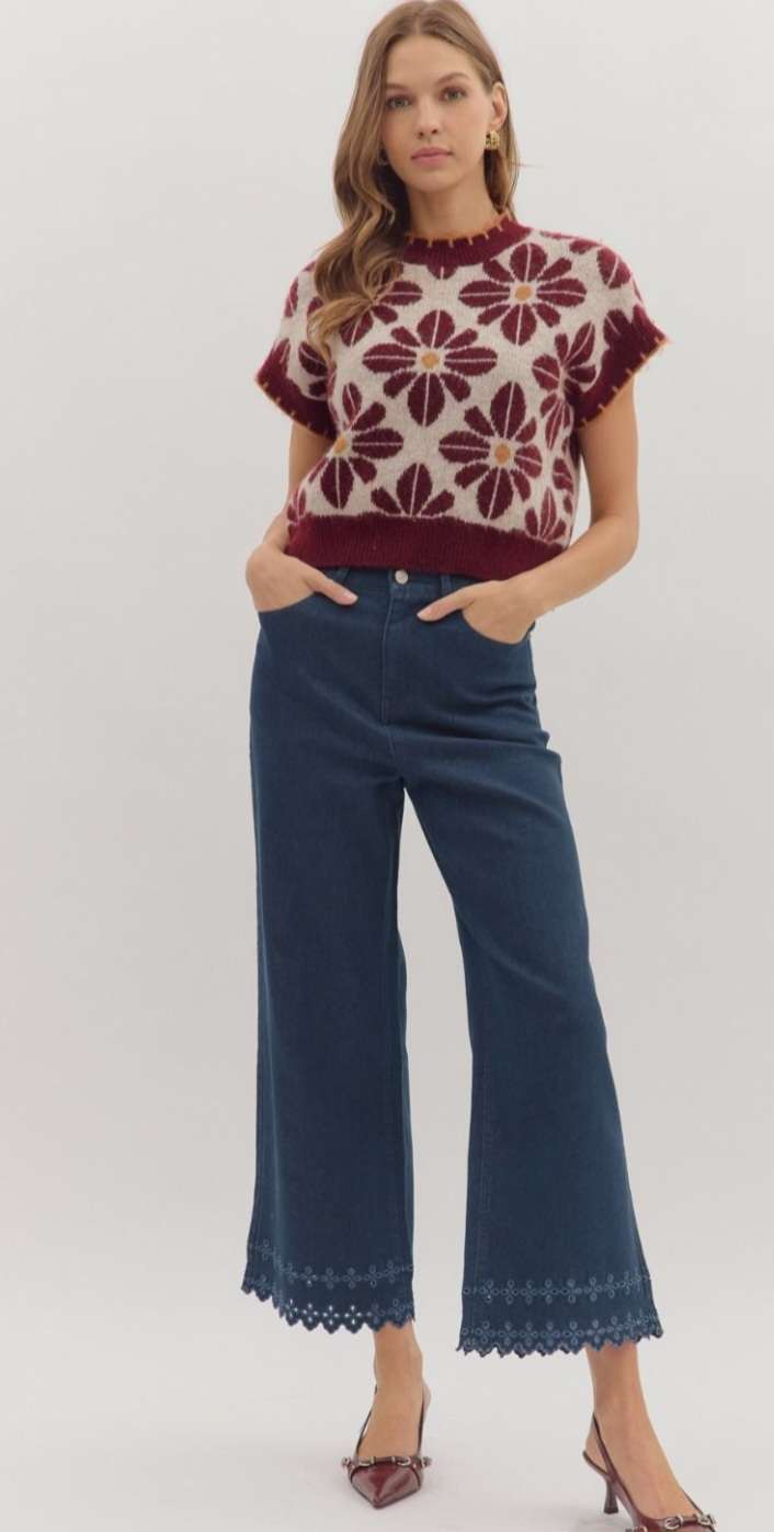 High-waisted brown denim pants featuring decorative eyelet hem