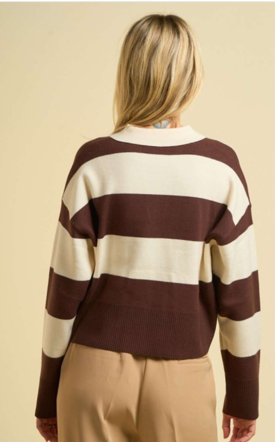 Women’s brown stripe sweater polo with classic collar, long sleeves, and ribbed cuffs, styled for a chic smart-casual look.