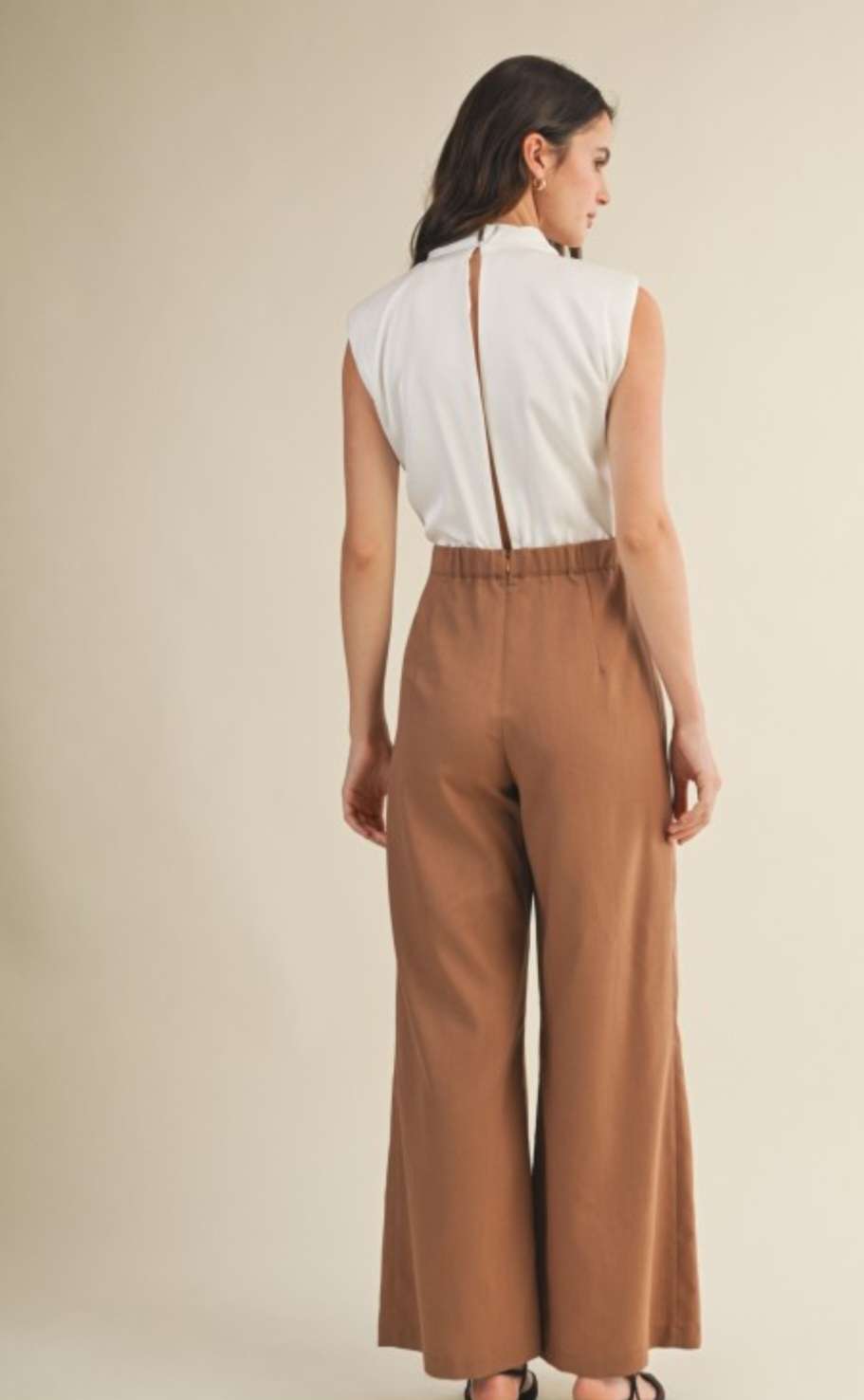Elegant two-tone cowl neck jumpsuit in camel and cream colorblock design