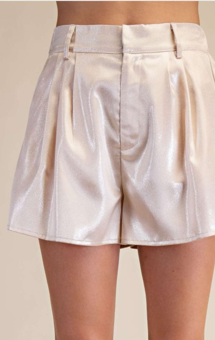 Elegant satin shorts in champagne tone featuring soft pleats and a tailored fit